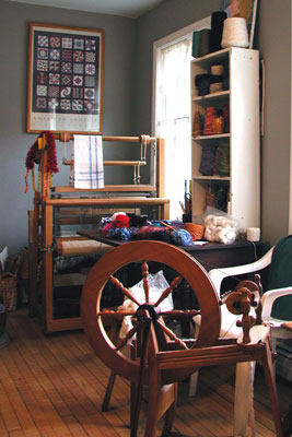 Set up for an Open Studio Weekend. Photo of small floor loom and a spinning wheel, Pine Ledge Fiber Studio, Fairfax, VT.