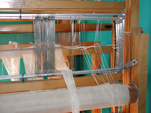 Threading Heddles Photo loom harnesses and heddles being threaded