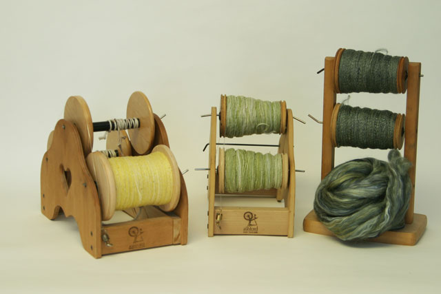 Photo of yarns on spinning bobbins, 2-ply and single cotton and single silk/merino, handspun by Joanne Littler, Pine Ledge Fiber Studio, Fairfax, VT.