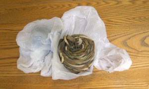 Photo of a ribbon yarn on a plastic grocery bag .